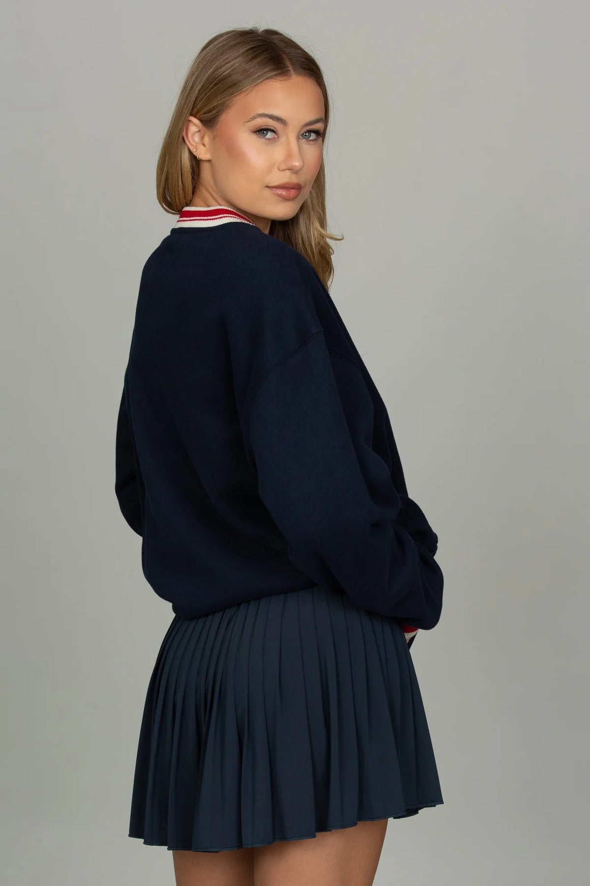 Back view of the GOLD HINGE Pleated Tennis Skirt in Dark Navy