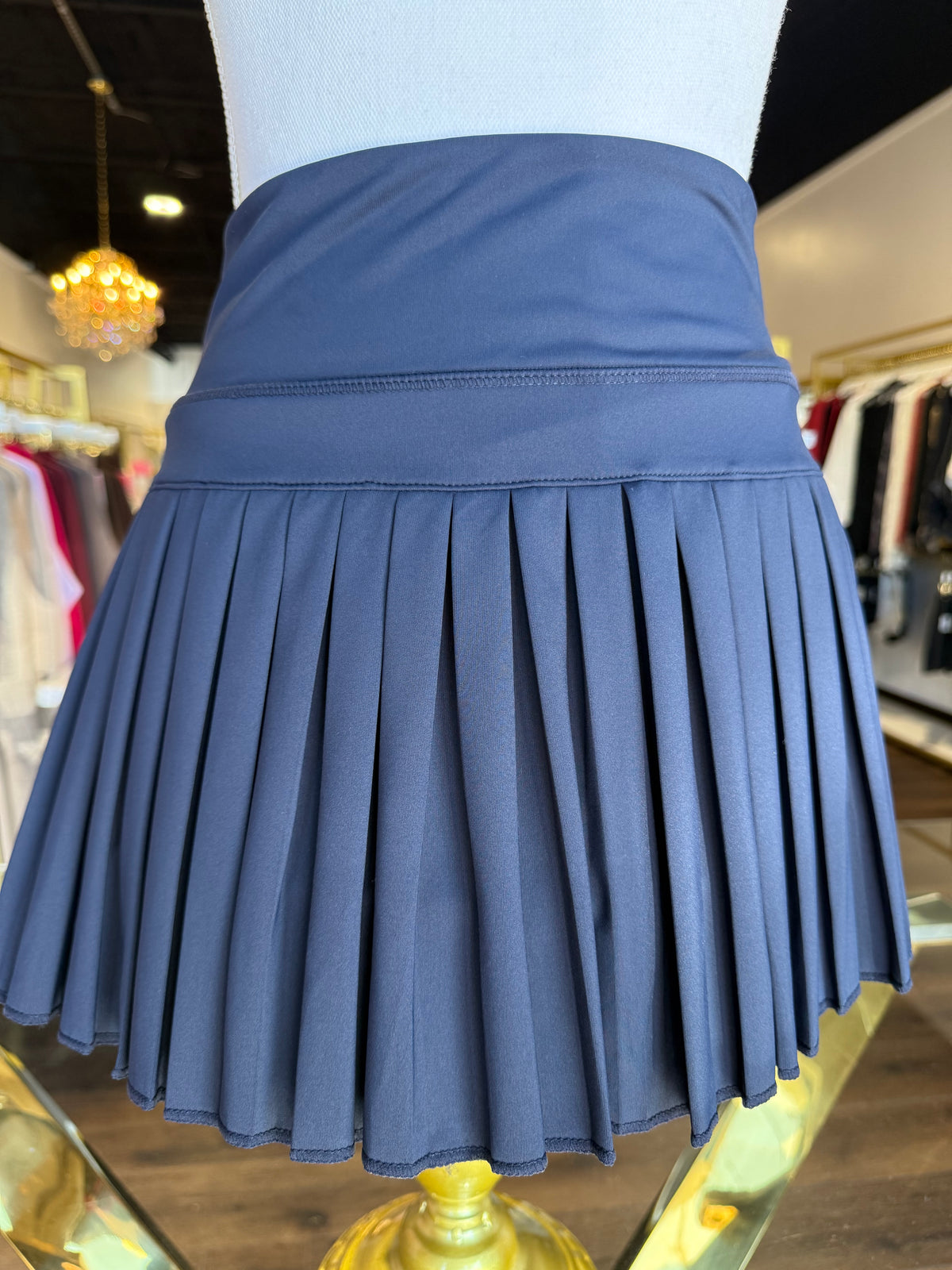 Gold Hinge pleated tennis skirt in Dark Navy, styled product photo