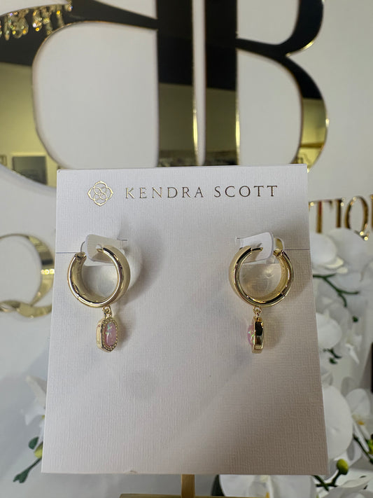 Gold KENDRA SCOTT hoop earrings with pink charms on a Kendra Scott card.