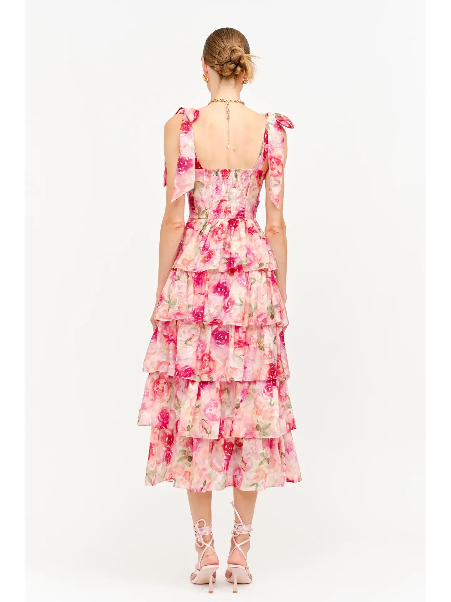 model wearing floral dress standing backwards