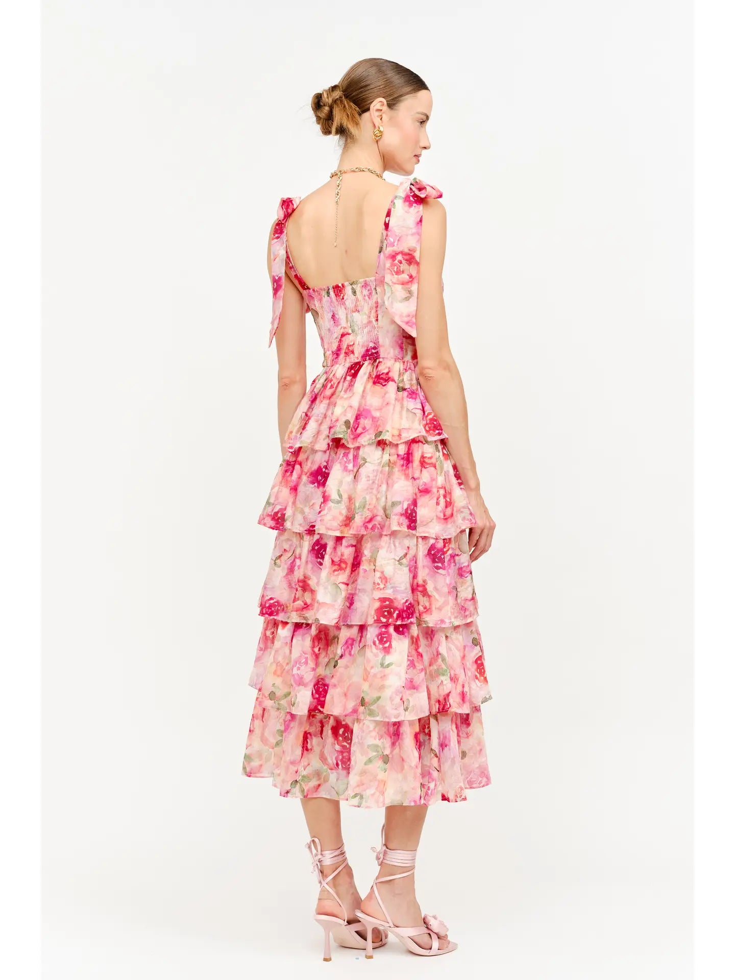 model wearing floral dress standing backwards and to the side