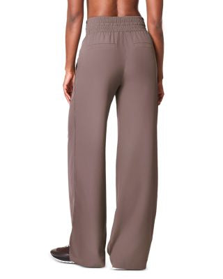 Brown pants worn by a person on a white background