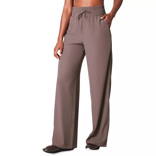 Brown wide-leg pants worn by a person on a white background