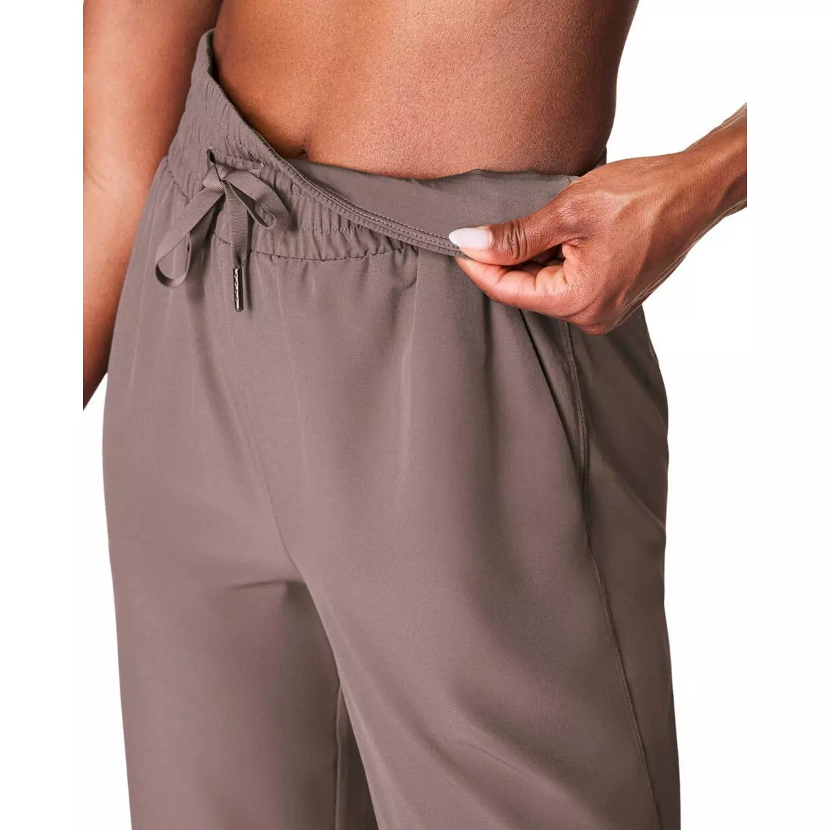 Brown Spanx brand pants with a drawstring waist on a white background