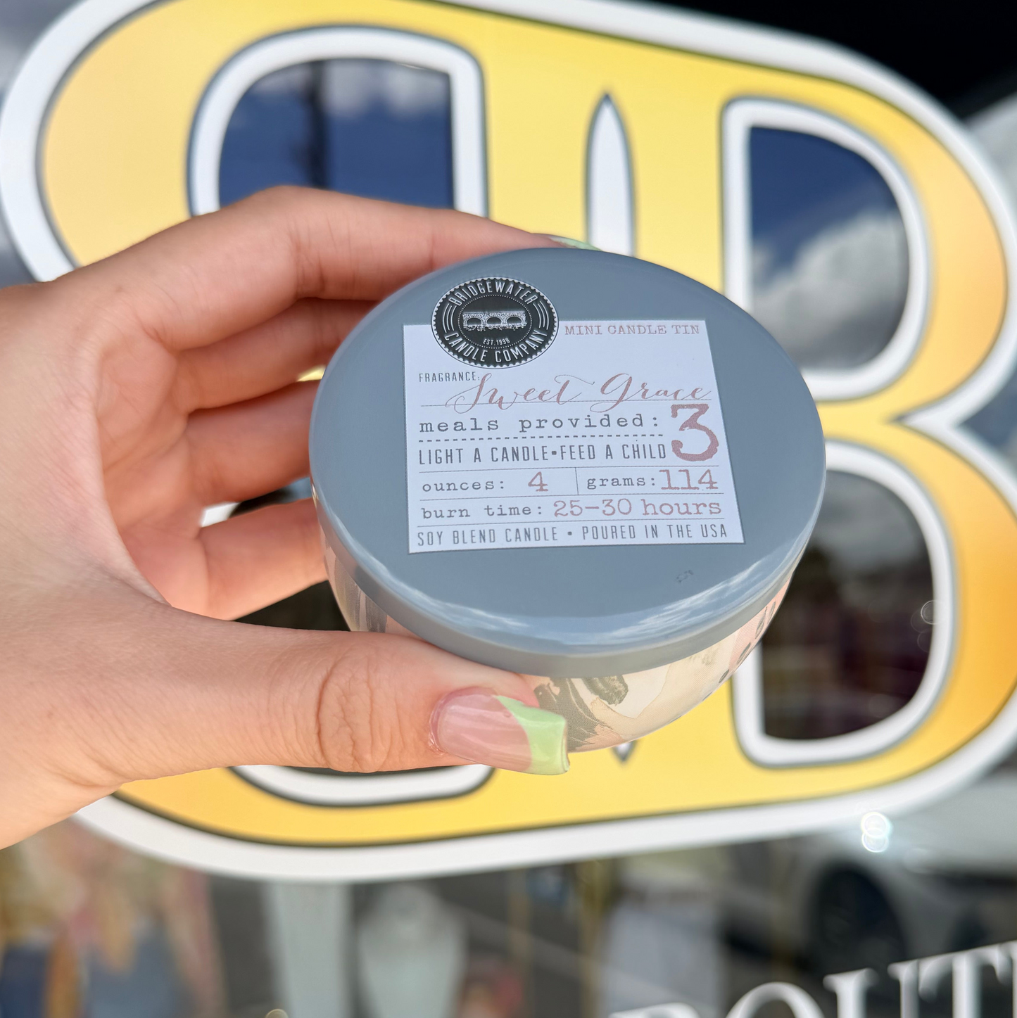 Sweet grace tin candle infront of bb 