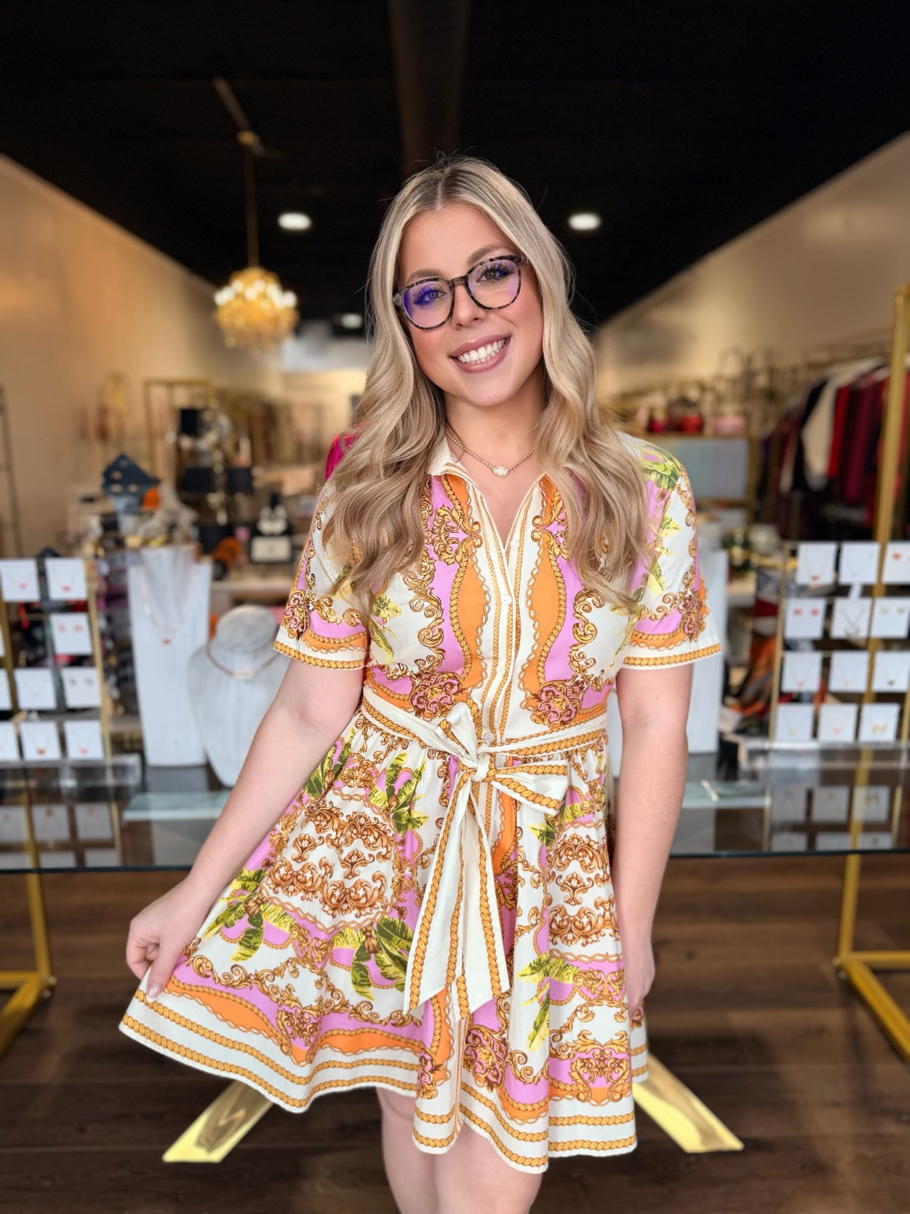 Woman wearing a patterned dress in a store setting