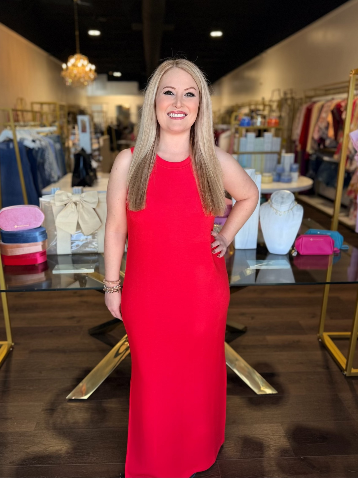 Model standing infront of store in red maxi tank dress 