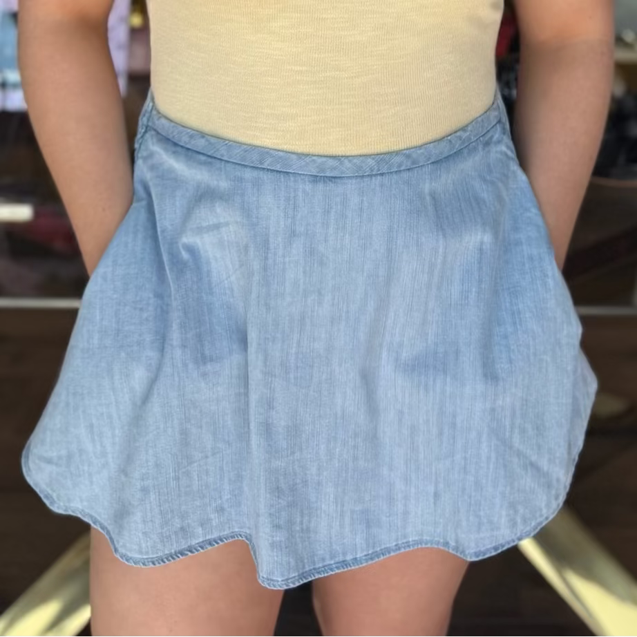 model wearing yellow top with lace trim and denim skirt 