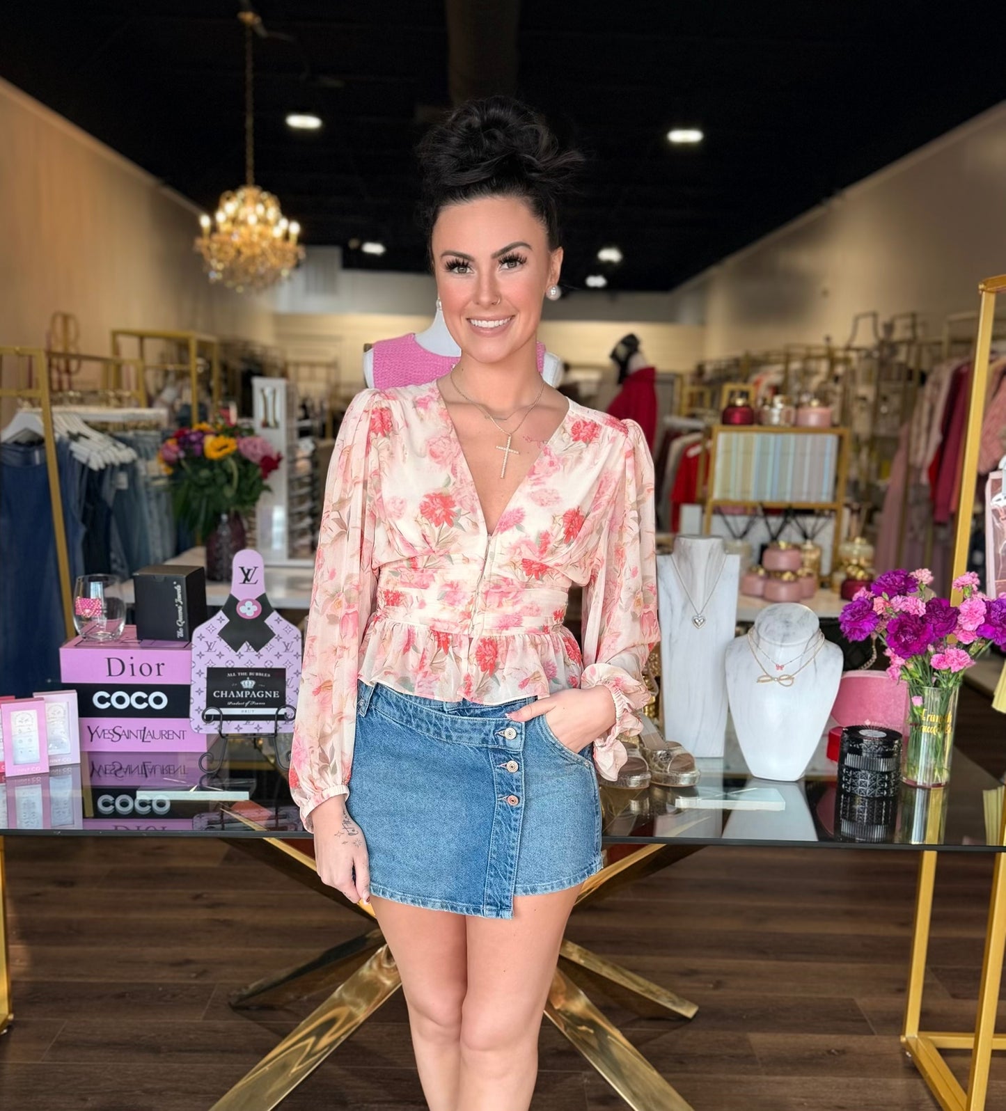 Model wearing floral v neck long sleeve blouse with a denim skirt