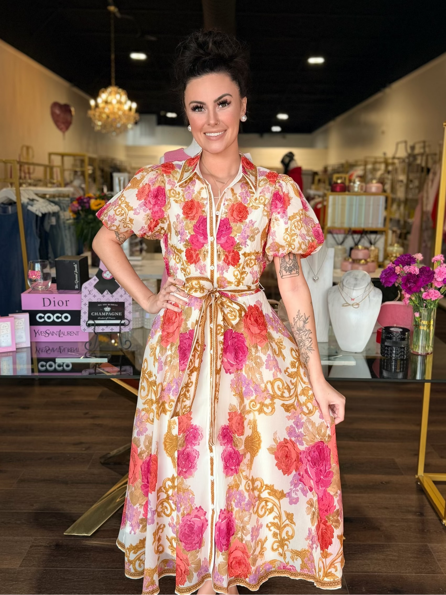 model wearing midi floral dress with gold details 
