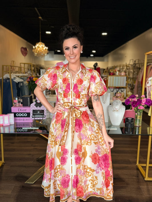 model wearing midi floral dress with gold details 