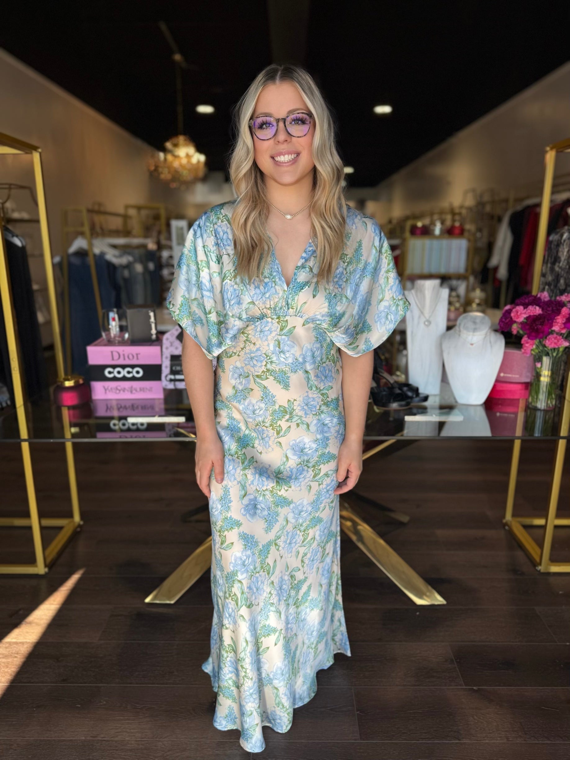 Model wearing v neck maxi dress with blue florals 