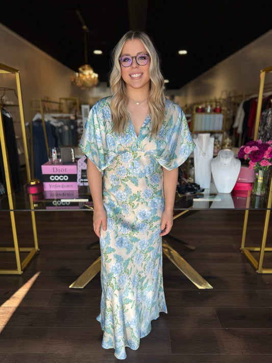 Model wearing v neck maxi dress with blue florals 