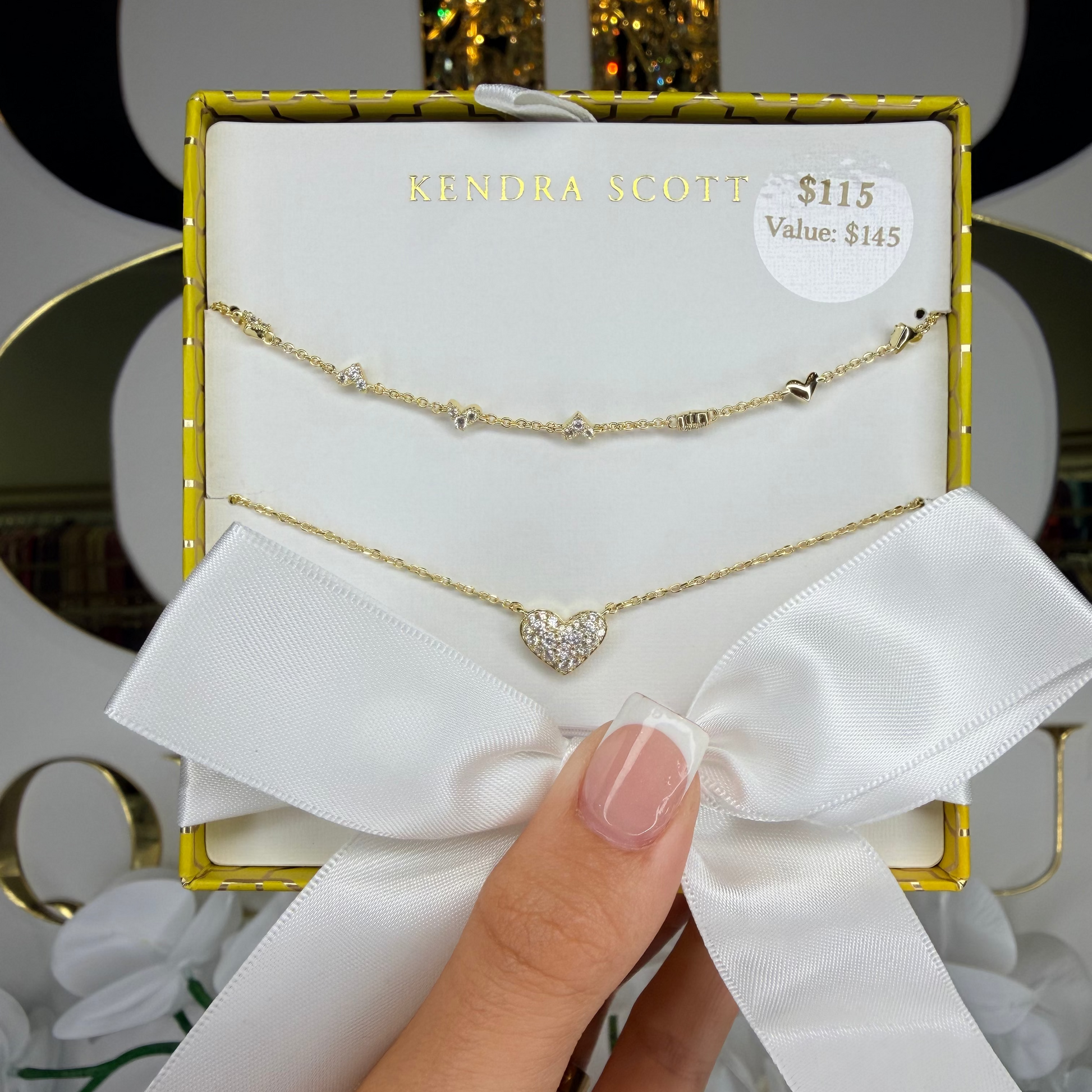 Hand holding gift box Kendra Scott Ari heart necklace 