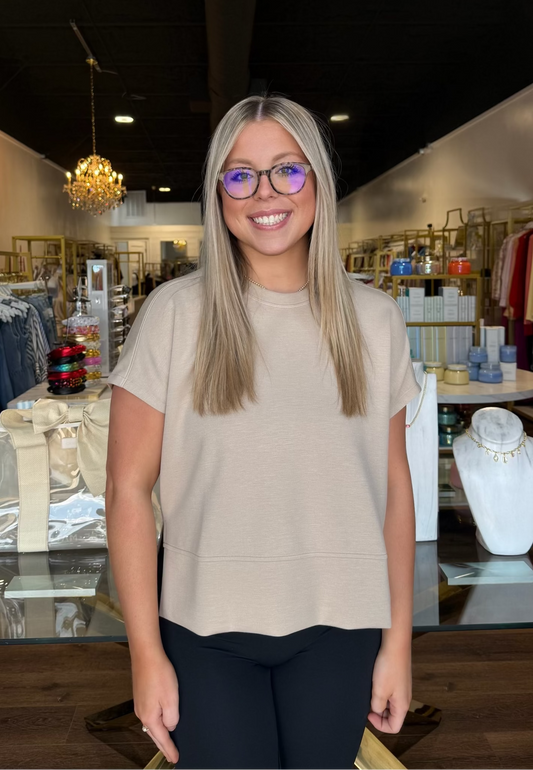 Model standing in front of store with dune color crewneck tee 