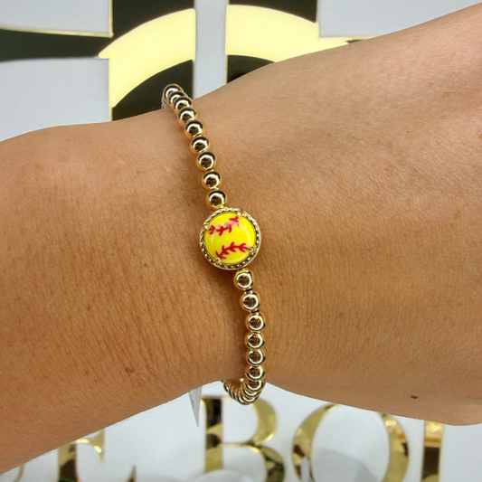 Bracelet with a colorful bead on a wrist, with a blurred background