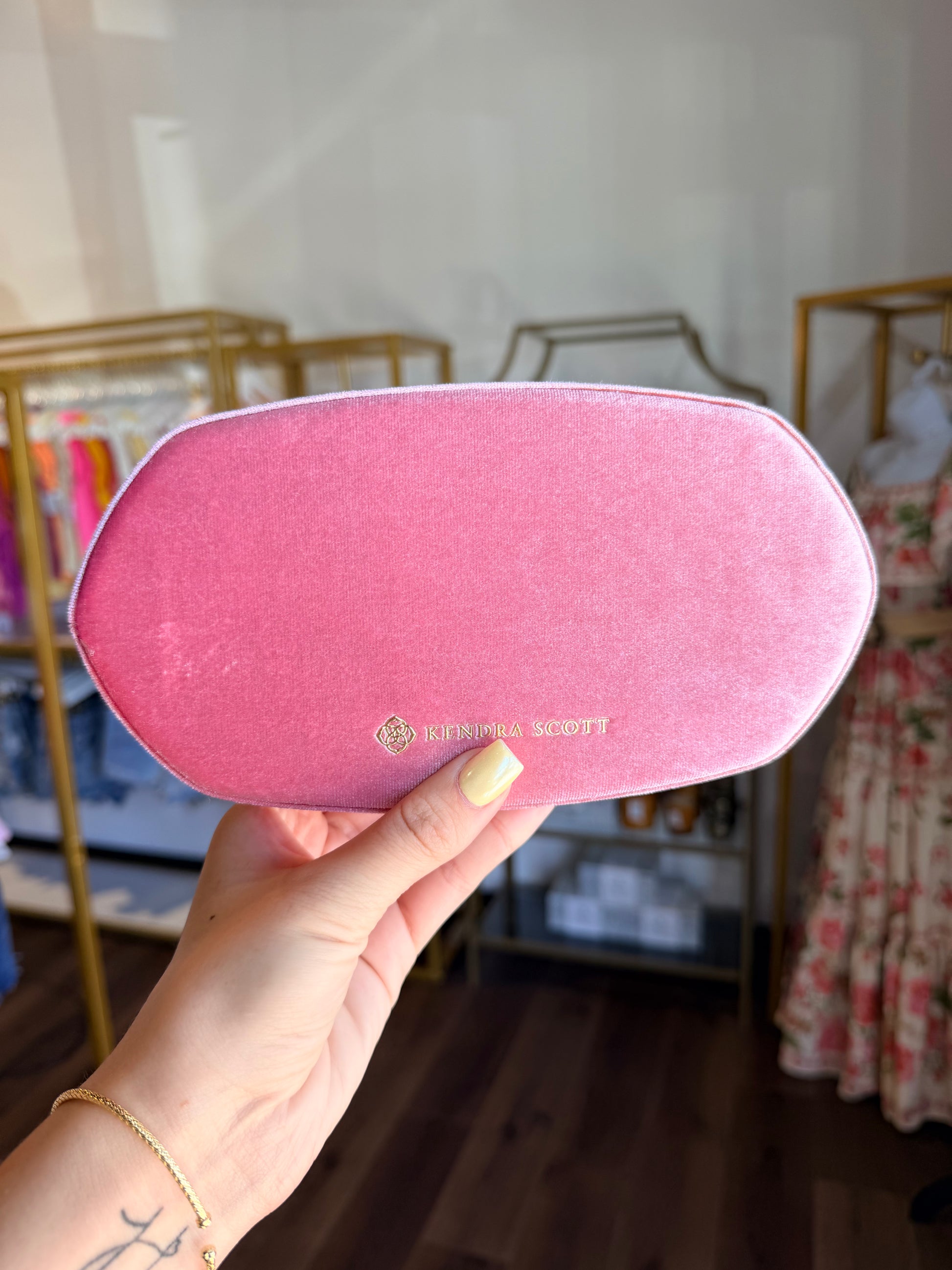 Light pink jewelry box for Kendra Scott in front of store 