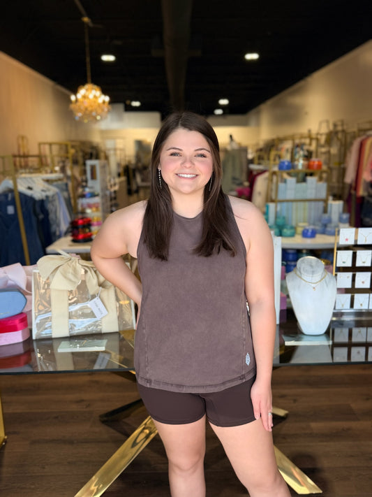 Model standing infront of store in brown free people twist tank 