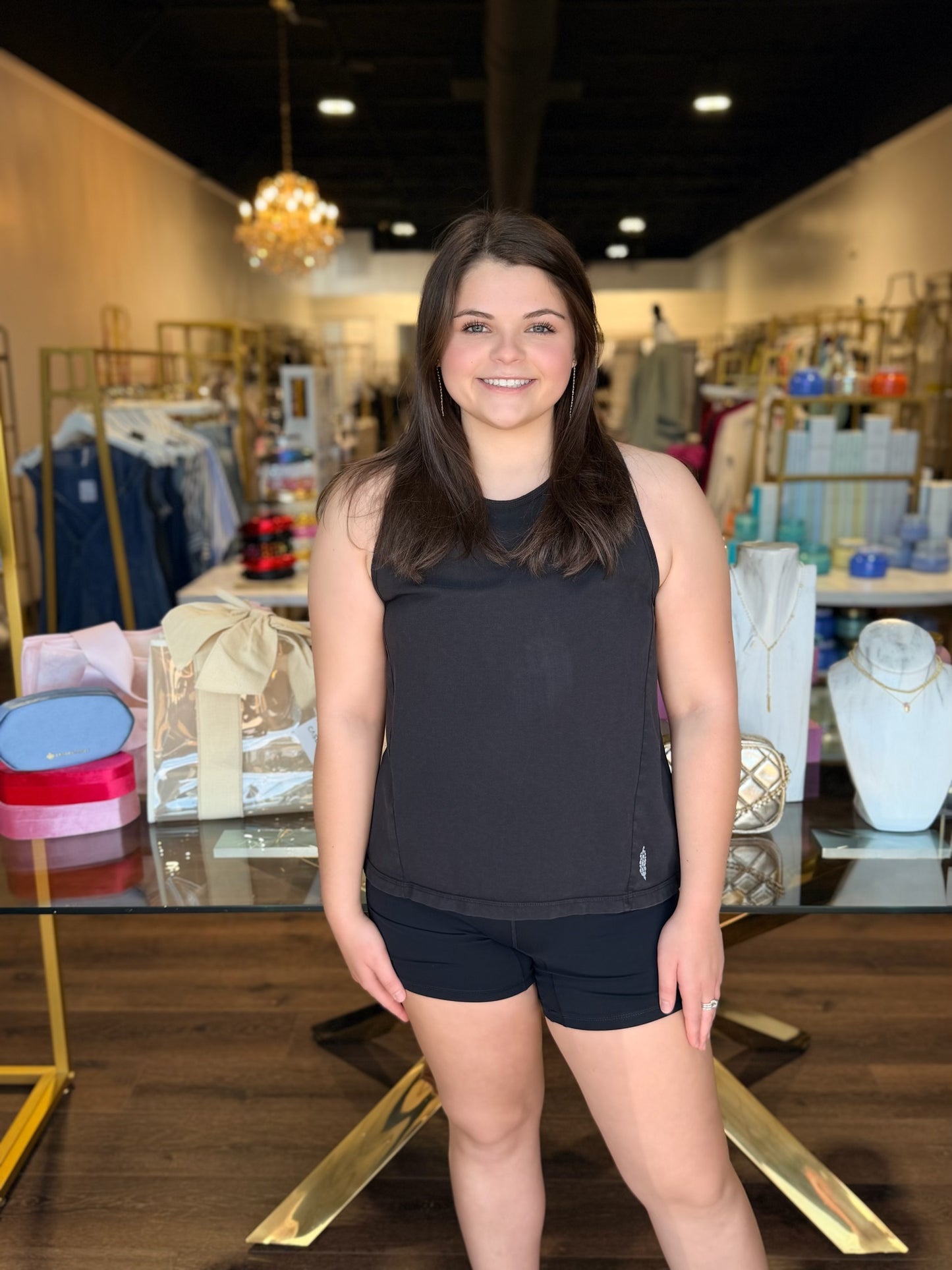 Model sanding in front of store with free people black twist tank 