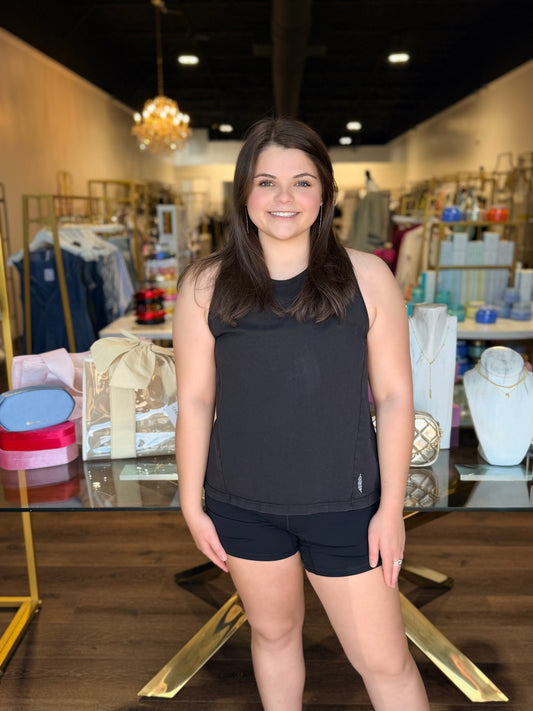 Model sanding in front of store with free people black twist tank 