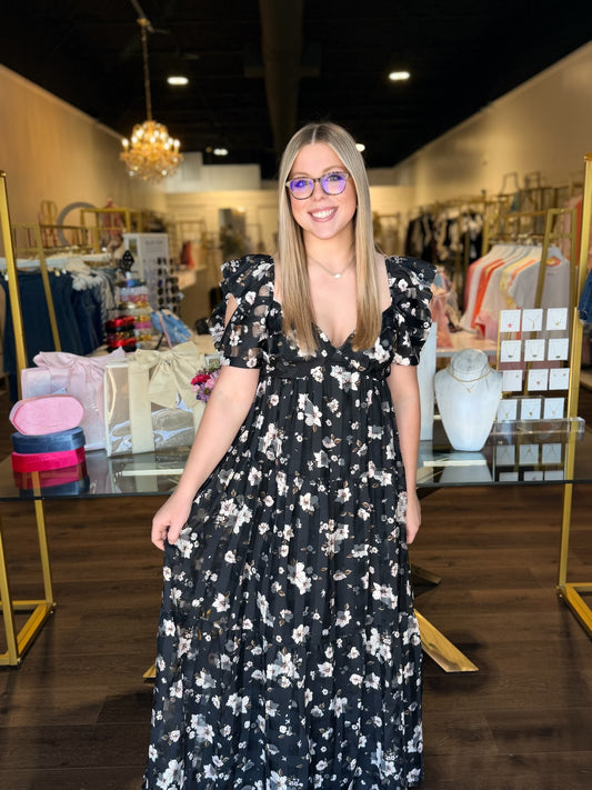 model wearing black with floral print maxi dress