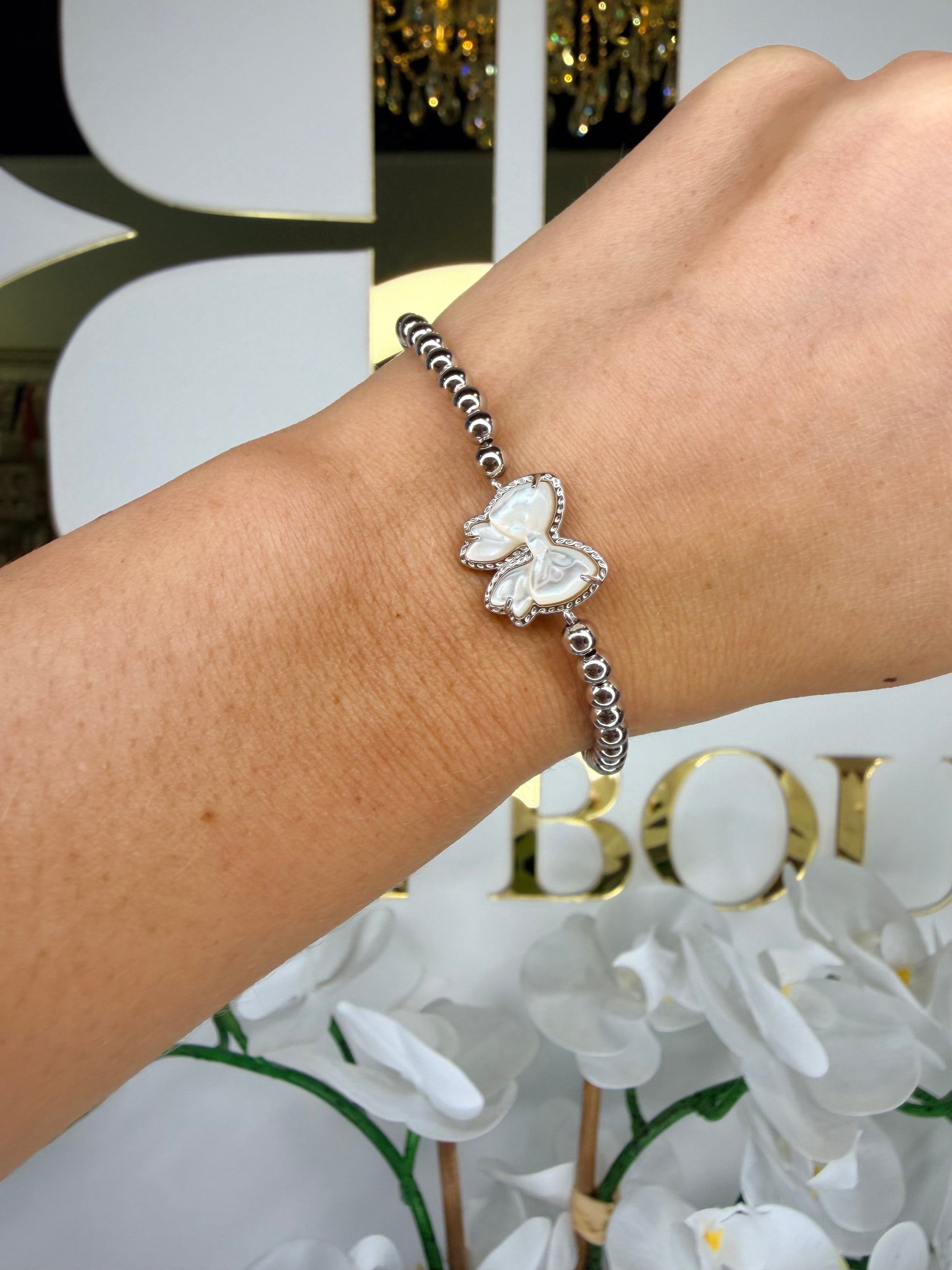 Kendra Scott bow silver beaded bracelet on wrist