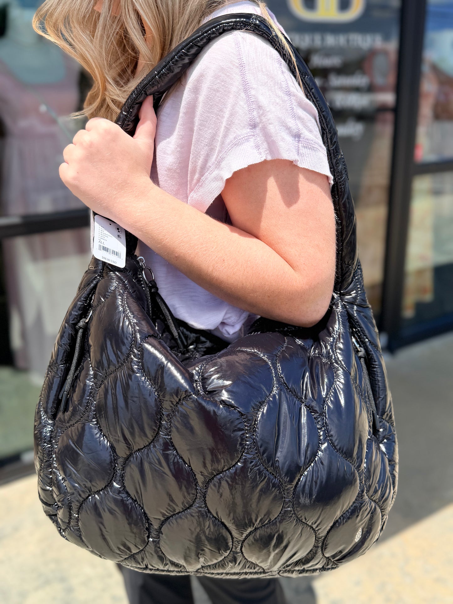 Black Free People puffer bag on model shoulder