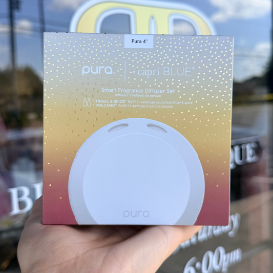 Pura smart fragrance diffuser gel packaging held in front of a store window.