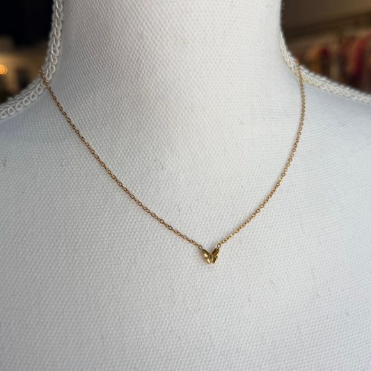 Gold necklace on a mannequin with a blurred background