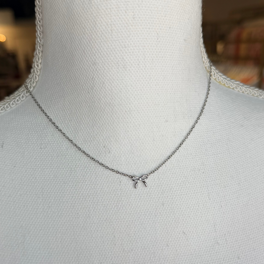 Mannequin wearing a delicate necklace with a blurred background.