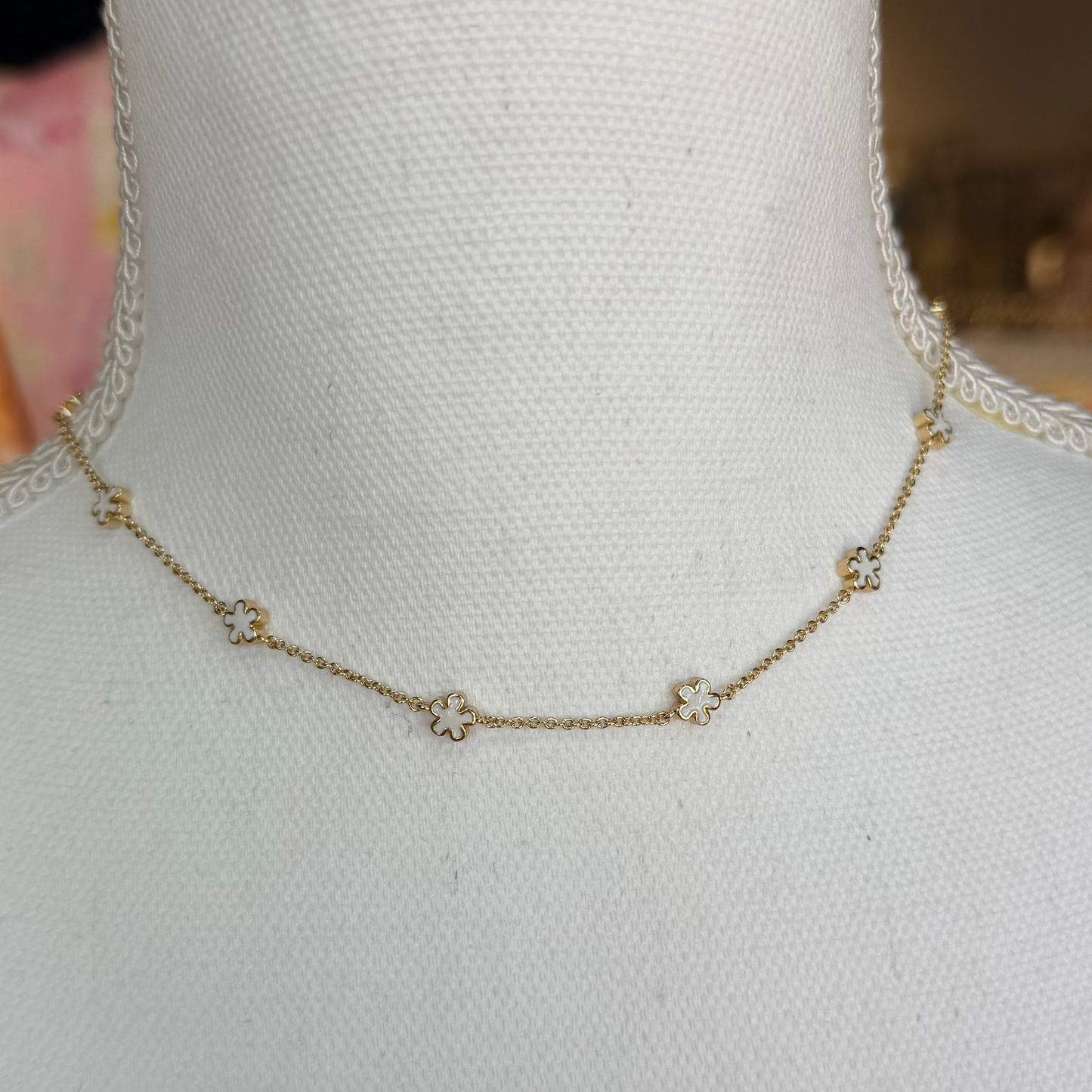 Gold necklace on a mannequin with a blurred background