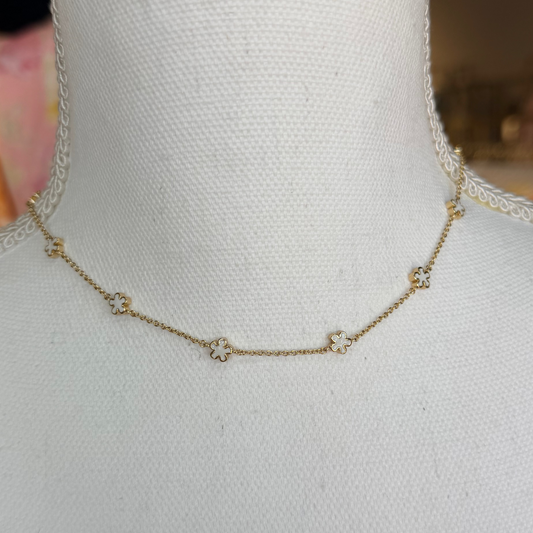 Gold necklace on a mannequin with a blurred background