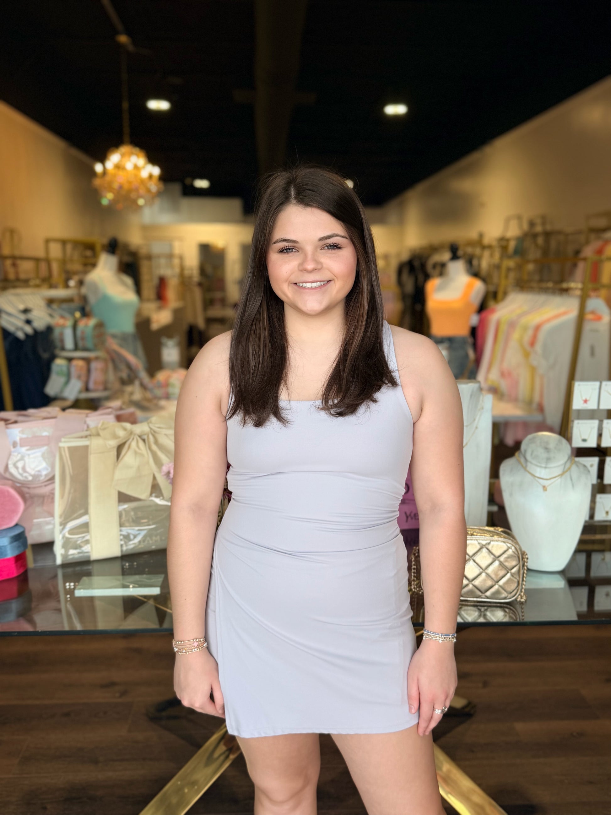 Model standing in front of store with purple never better dress 