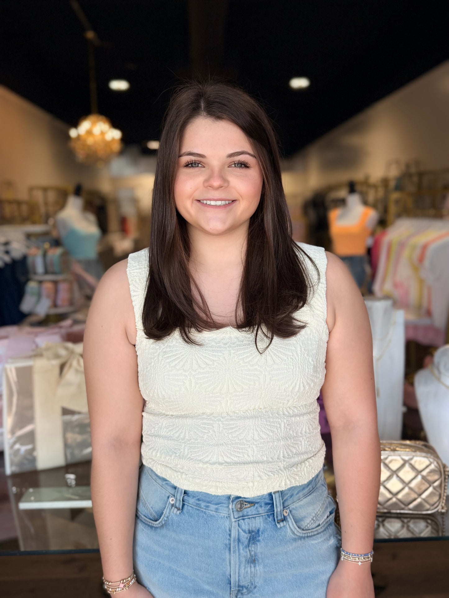 Model standing infront of store with love letter cami on in white 