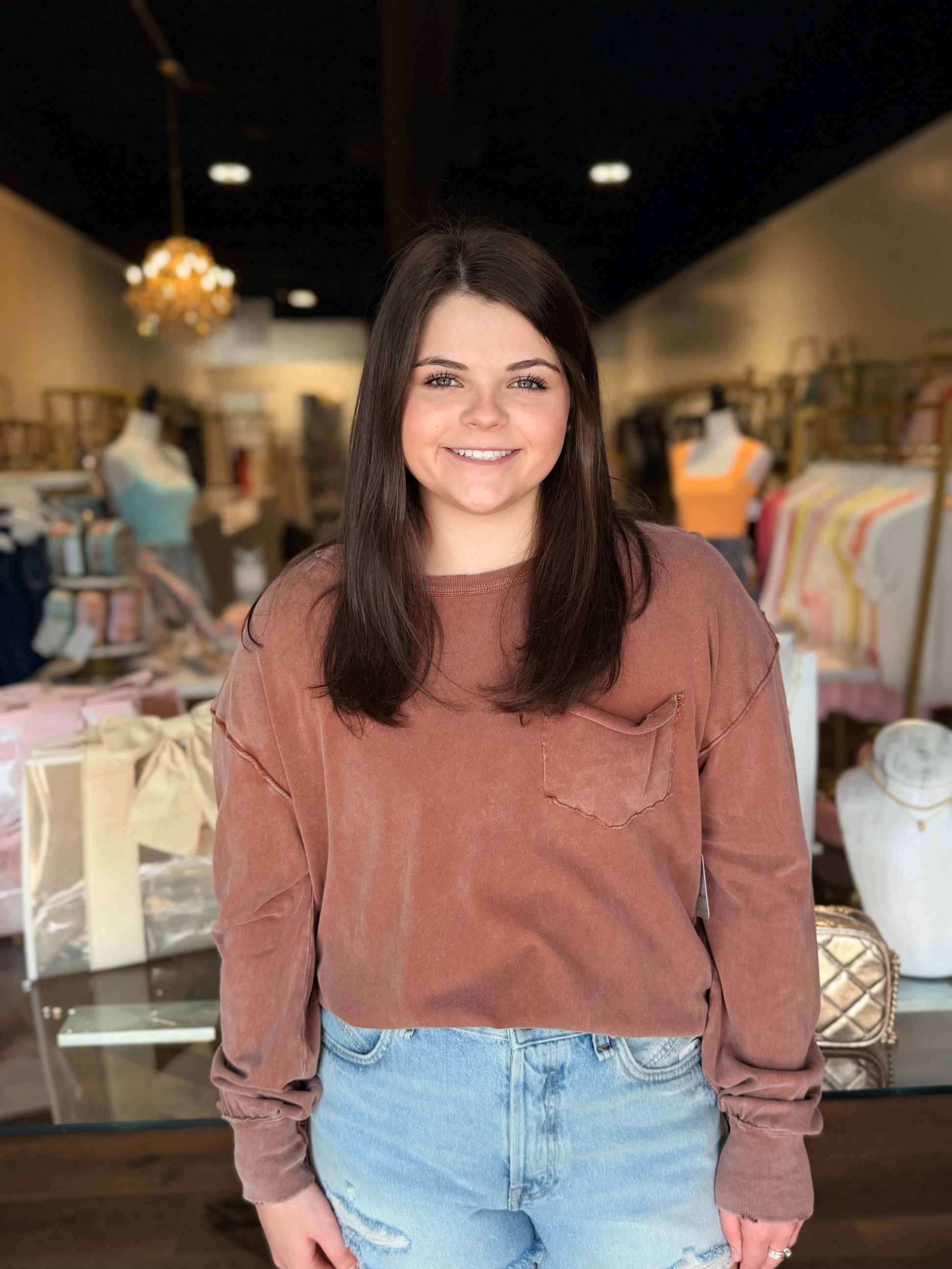 Model in front of store with brown free people long sleeve shirt 