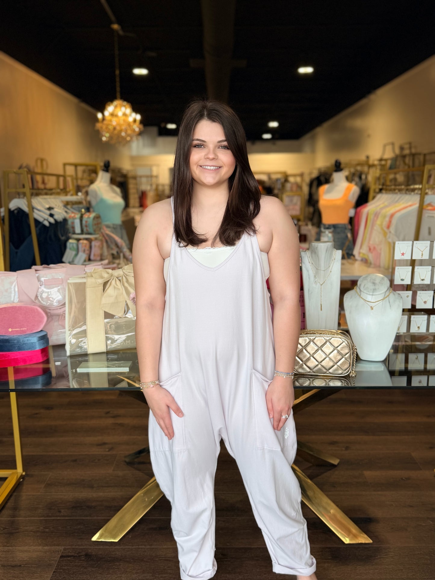 Model standing infront of store in hot shot purple onesie 