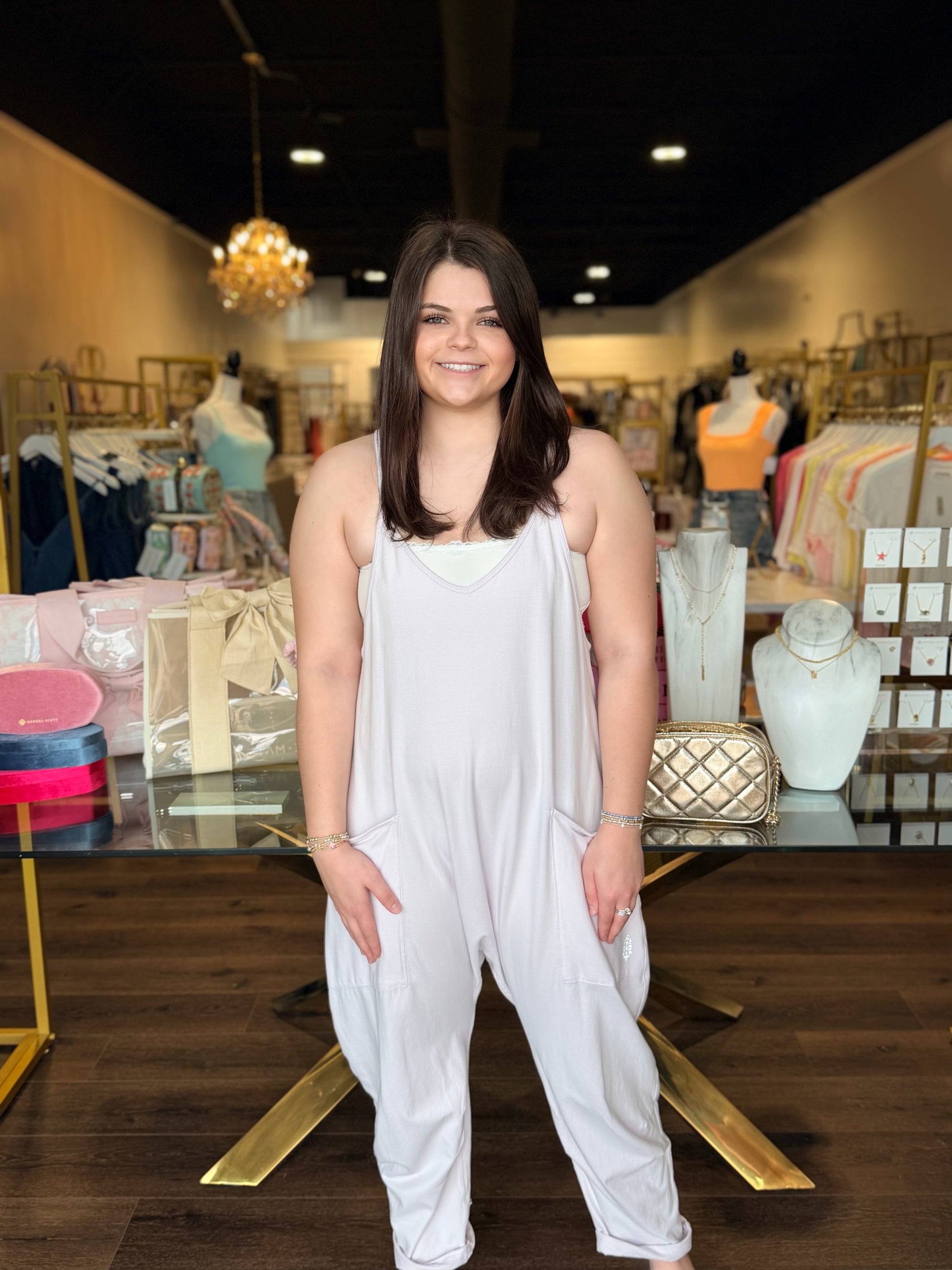 Model standing infront of store in hot shot purple onesie 