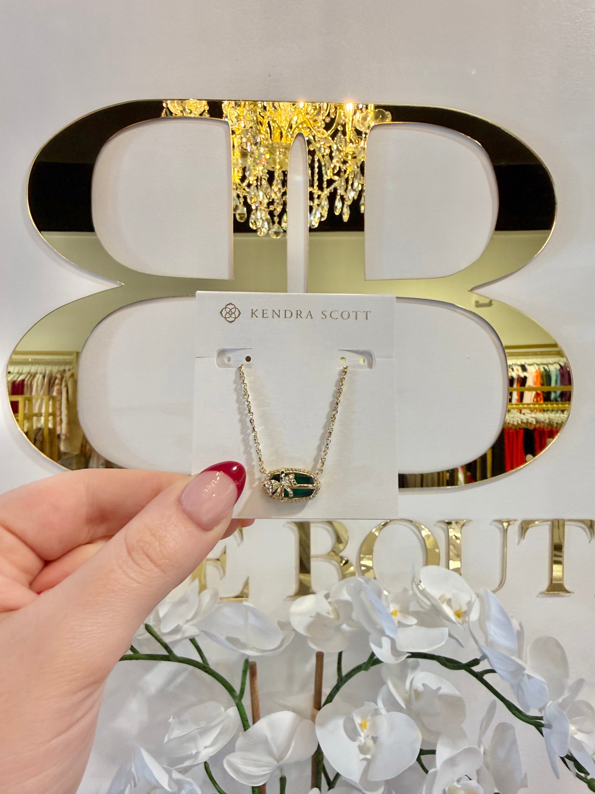 BOUTIQUE KENDRA SCOTT ELISA BOW GOLD SHORT PENDANT NECKLACE IN PINE ILLUSION IN HAND