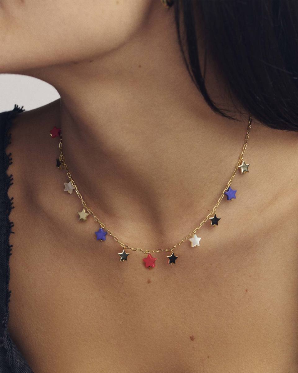 Necklace with colorful star-shaped pendants on a person's neck