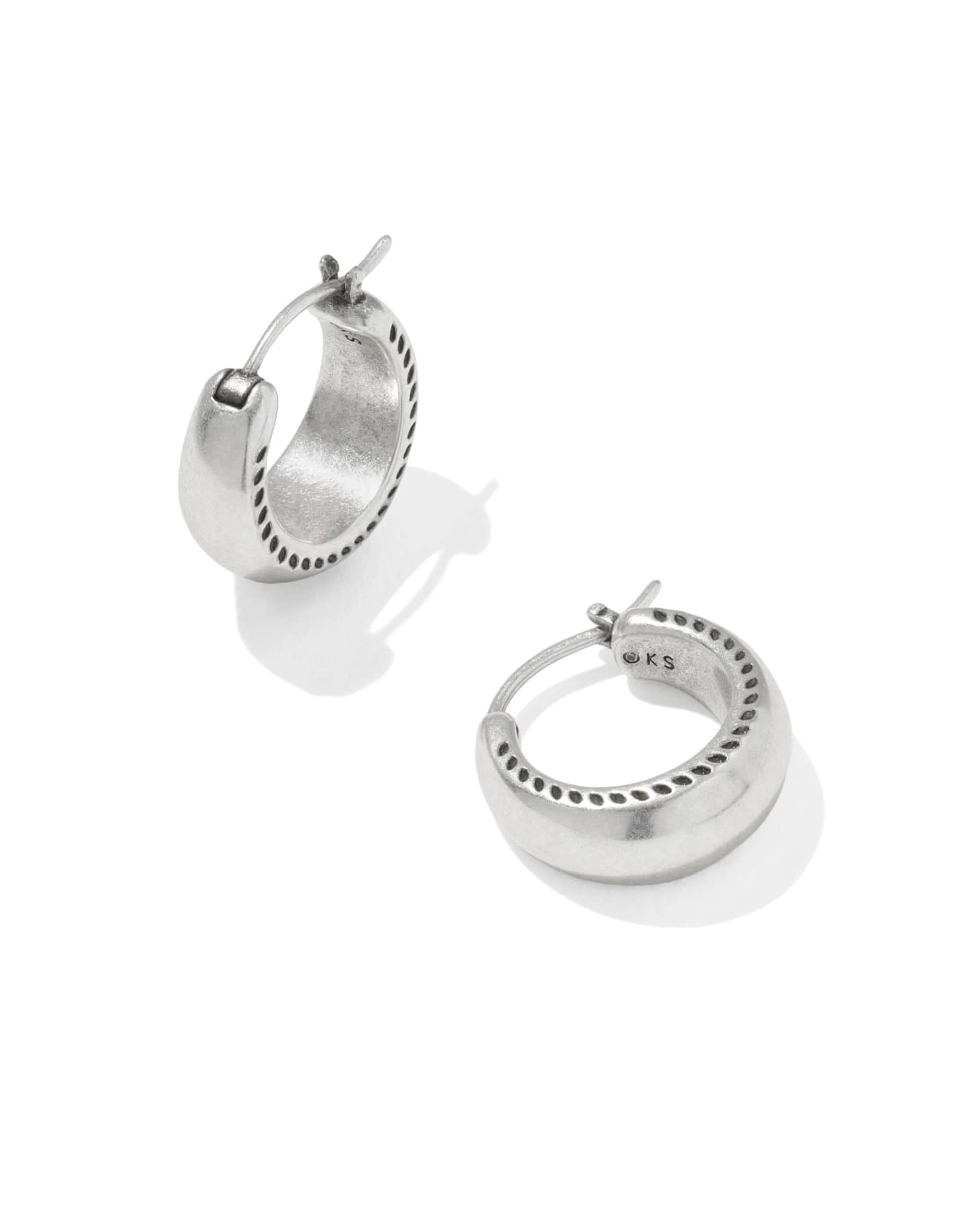 Silver hoop earrings on a white background