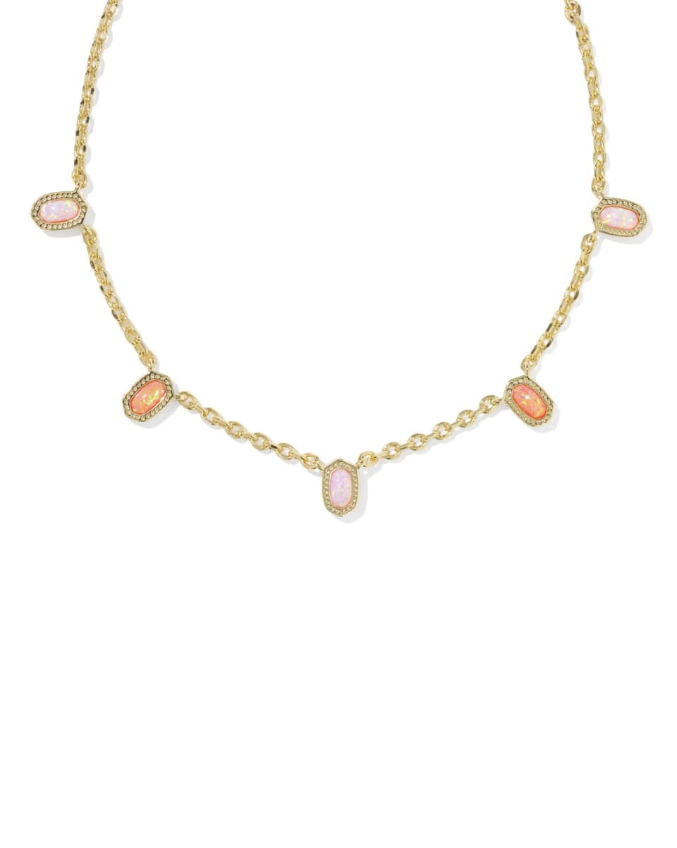 Gold necklace with pink gemstones on a white background