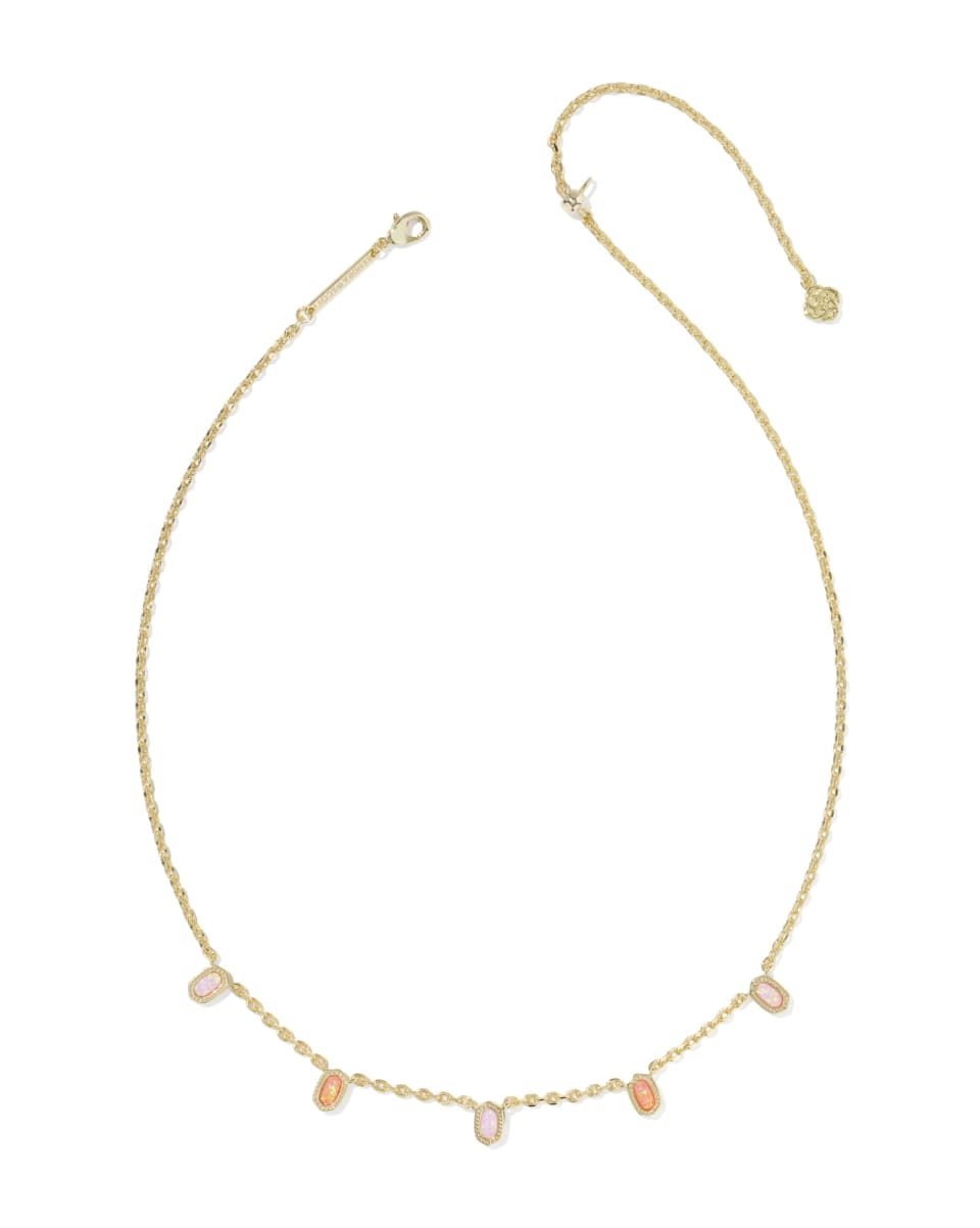Delicate gold necklace with small pearls on a white background