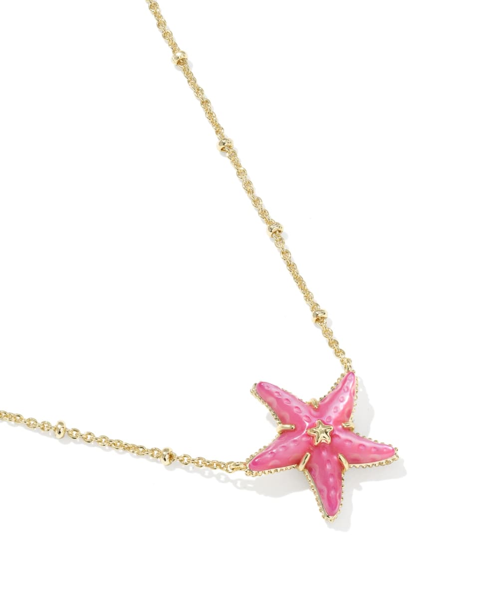 Pink starfish pendant on a gold chain against a white background