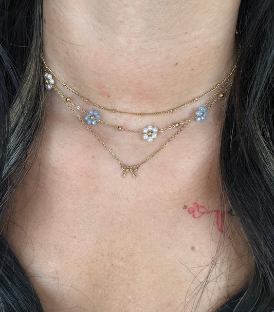 BOUTIQUE  LINNY CO GOLD FLOWER BLUE PEARL GRACIE NECKLACE ON MODEL