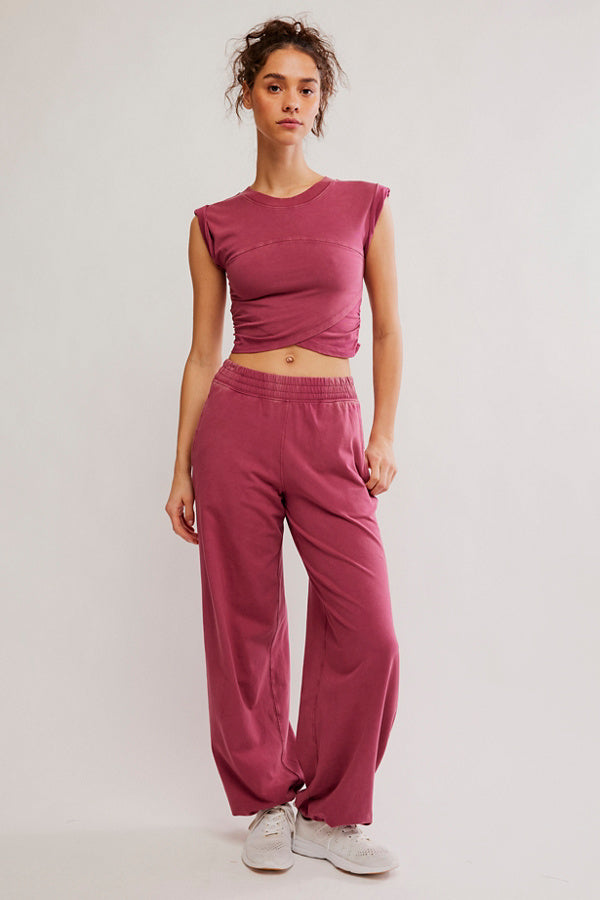 Woman wearing a pink outfit on a plain background