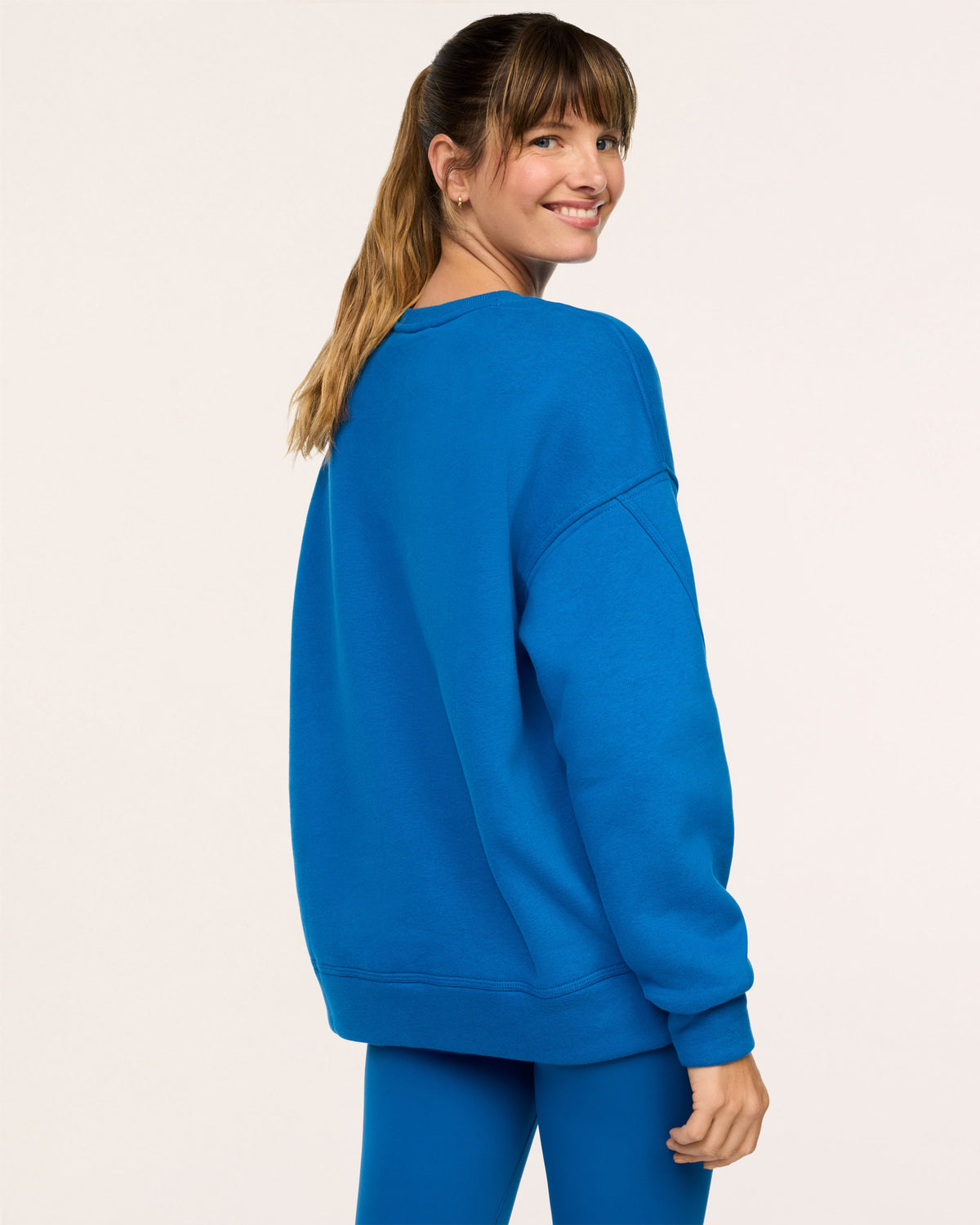Model showing back of SPANX® BoostUp Cotton Fleece Crewneck Tunic - Cadet Blue