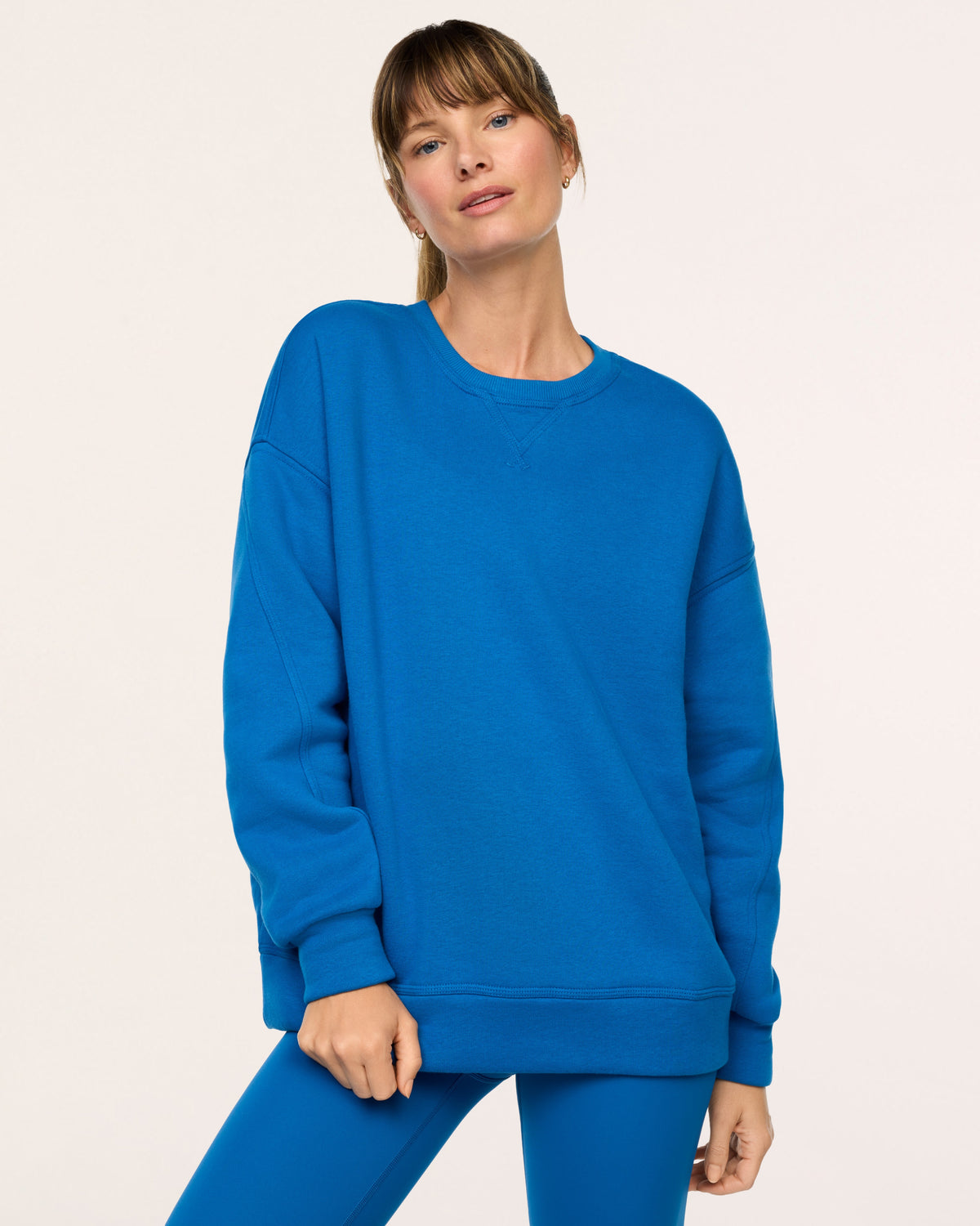 Model wearing SPANX® BoostUp Cotton Fleece Crewneck Tunic - Cadet Blue with white background