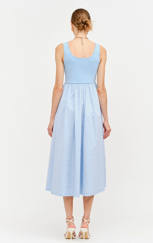 Woman wearing a light blue dress on a white background