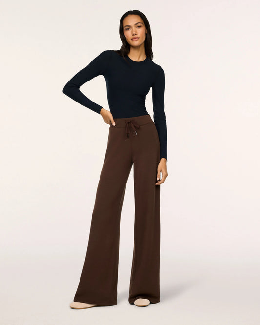Model wearing Spanx Wide Leg Pants Umber Root with white background.