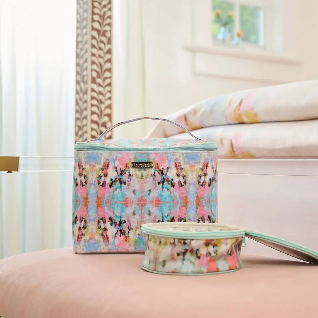 Two patterned bags on a bed with a blurred background